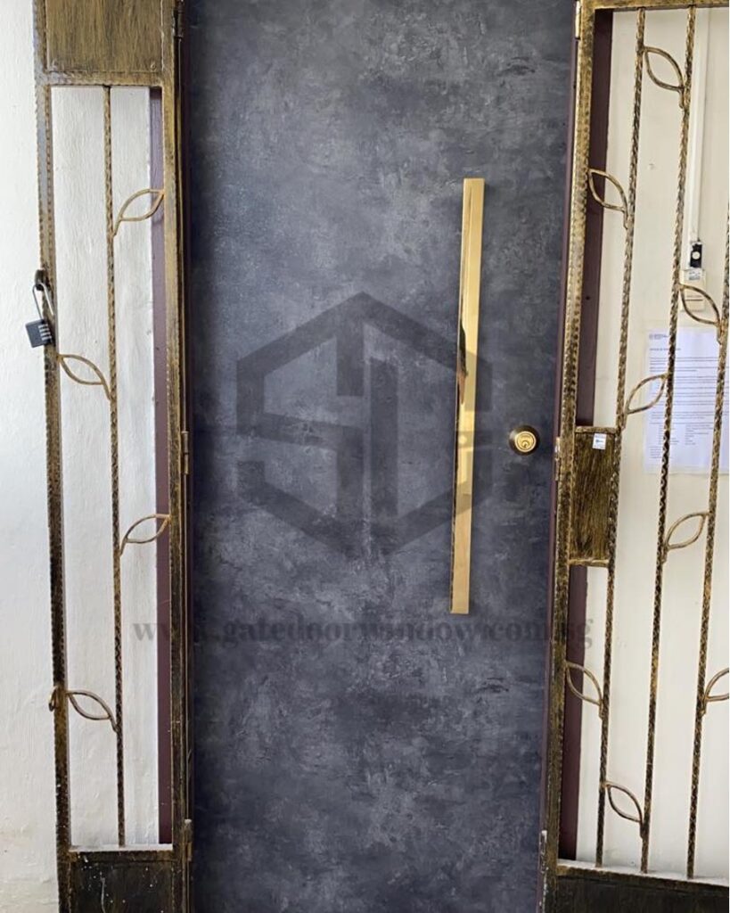 Black front door with a gold handle