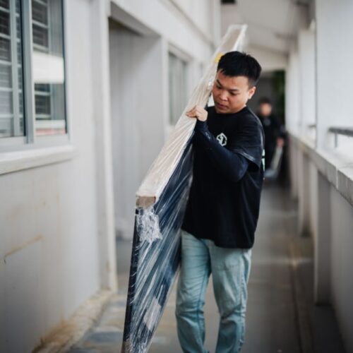 gdw employees carry mild steel gate to customer's house